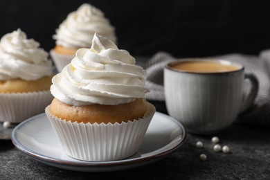 Photo of Delicious cupcakes with cream on grey table, closeup