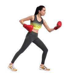 Beautiful woman in boxing gloves training on white background