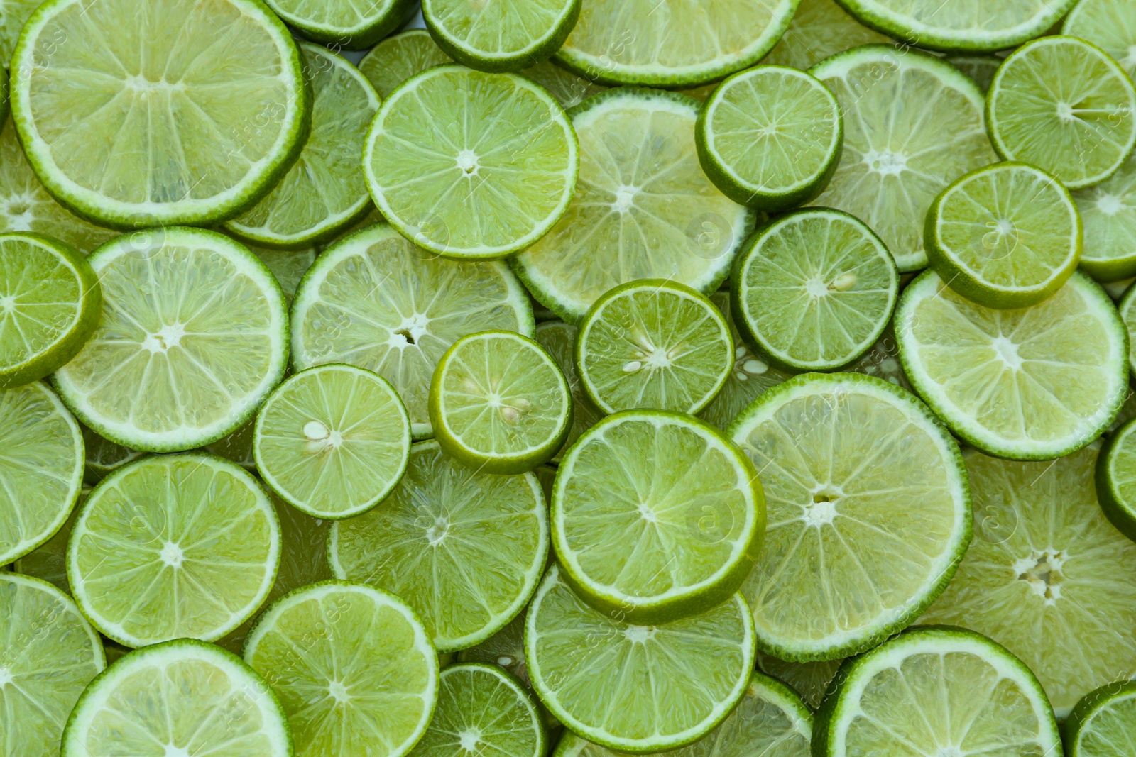 Photo of Fresh lime slices as background, top view