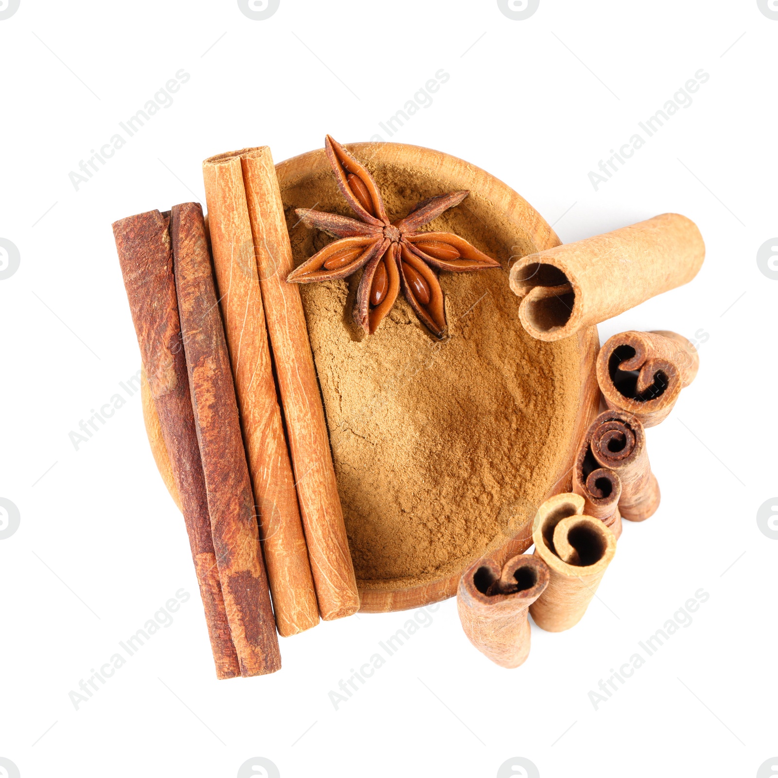 Photo of Dry aromatic cinnamon sticks, powder and anise star isolated on white, top view