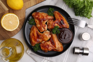 Photo of Flat lay composition with marinade and chicken wings on white table