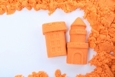 Castle and tower made of kinetic sand on white background, top view