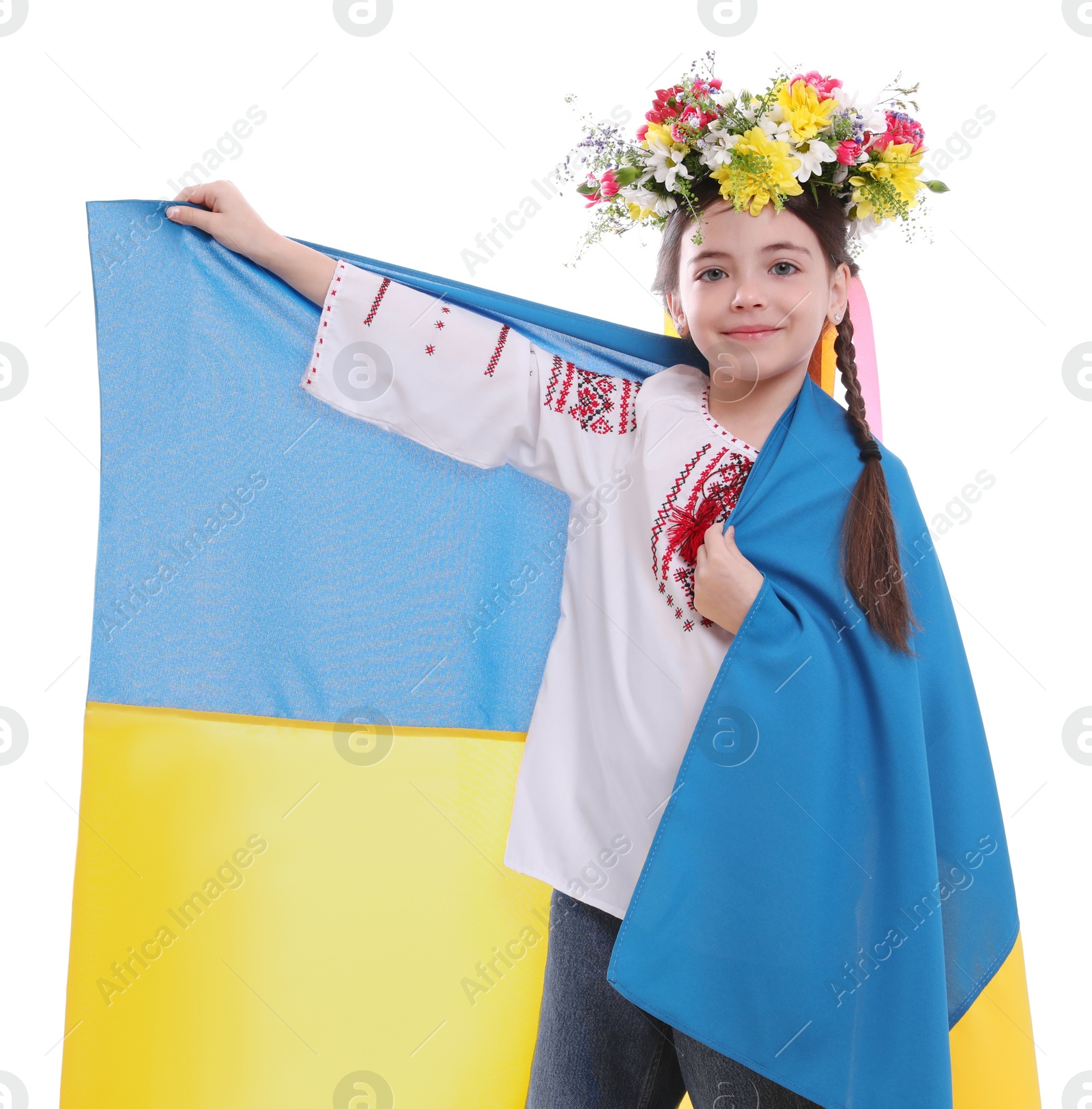 Photo of Little girl in national clothes with flag of Ukraine on white background