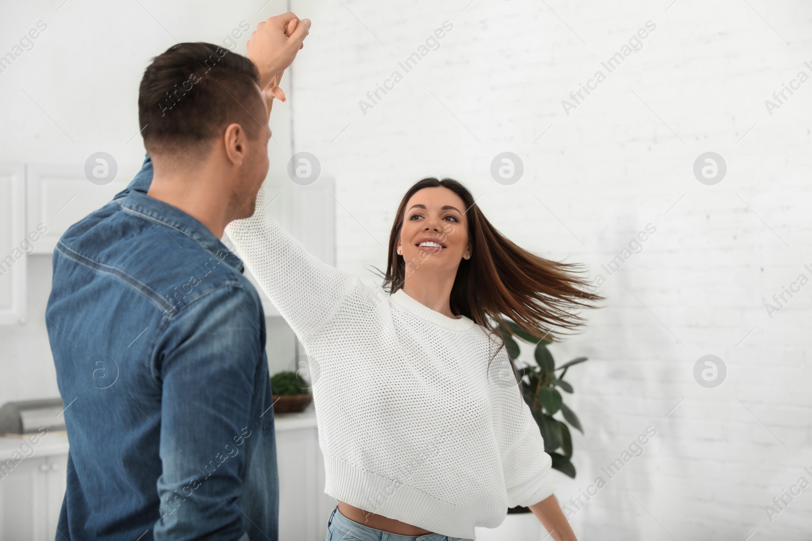 Photo of Happy couple dancing in kitchen at home