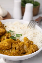 Photo of Delicious chicken curry with rice on table, closeup