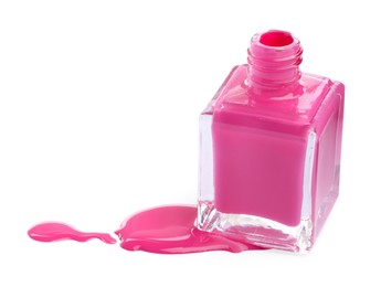 Photo of Bottle and spilled pink nail polish isolated on white