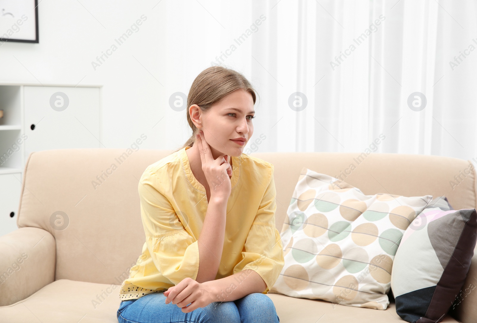 Photo of Young woman checking pulse in living room