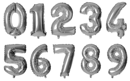 Image of Set with silver foil balloons in shape of numbers on white background