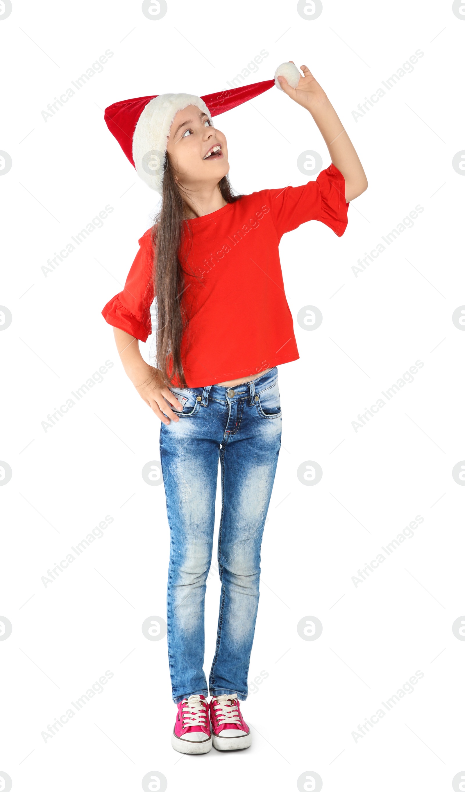 Photo of Cute little child in Santa hat on white background. Christmas celebration