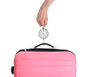 Photo of Man weighing stylish suitcase against white background, closeup