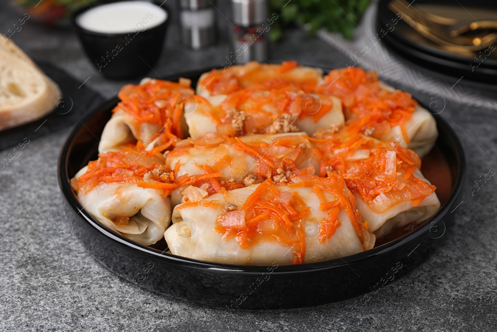 Photo of Delicious cabbage rolls served on grey table, closeup