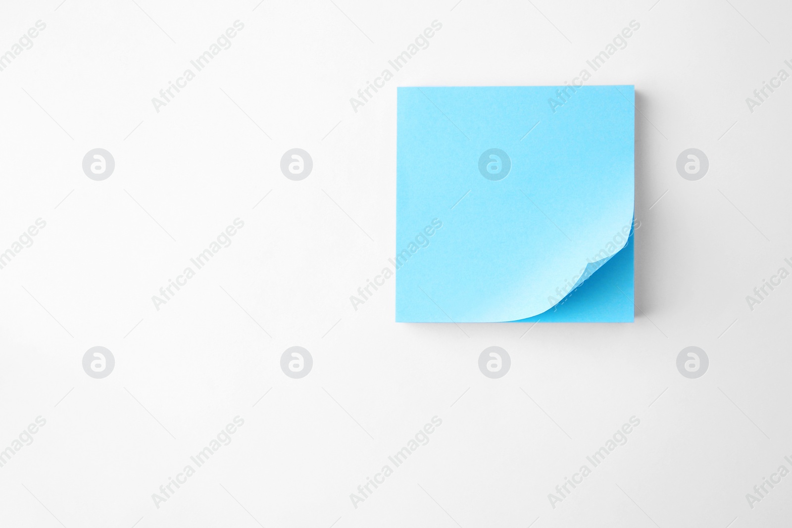 Photo of Blank paper note on white background, top view. Space for text