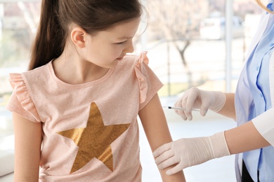 Photo of Doctor vaccinating little girl in hospital