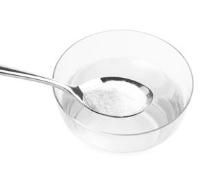 Photo of Spoon with baking soda over glass of water on light background, closeup