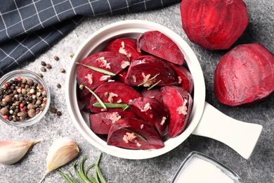 Photo of Flat lay composition with raw beetroot slices on grey table