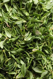 Photo of Pile of fresh green thyme leaves as background, top view