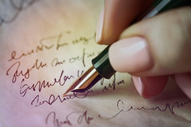 Image of Woman writing letter with fountain pen, closeup