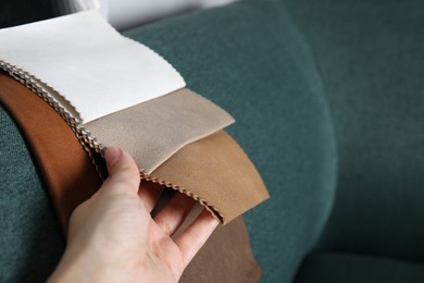 Woman choosing fabric among colorful samples on green sofa, closeup. Space for text