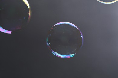 Photo of Beautiful transparent soap bubbles on gray background