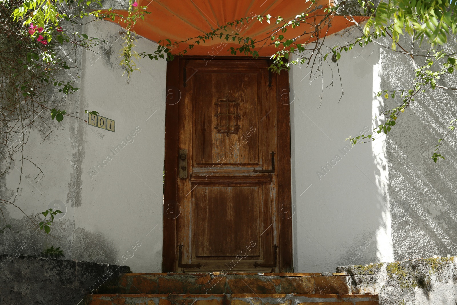 Photo of House entrance with old wooden door outdoors