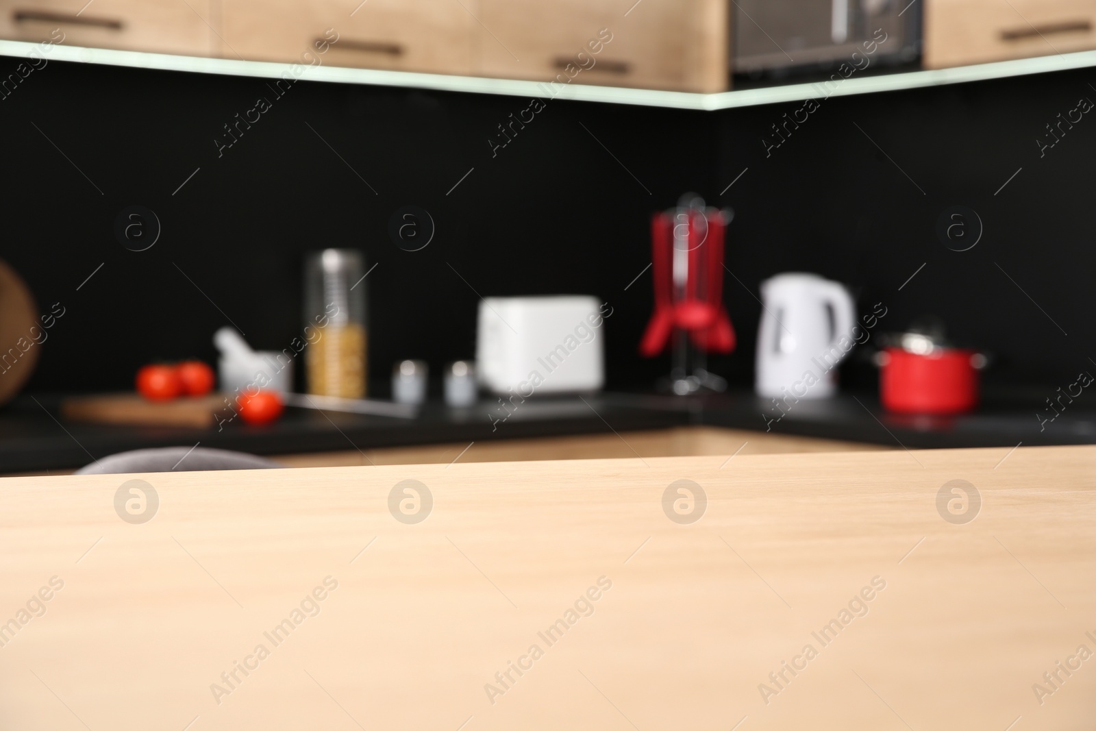 Photo of Countertop and blurred view of kitchen interior on background