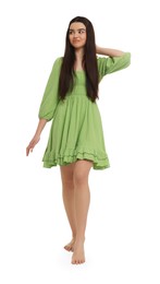 Photo of Beautiful girl in green dress on white background