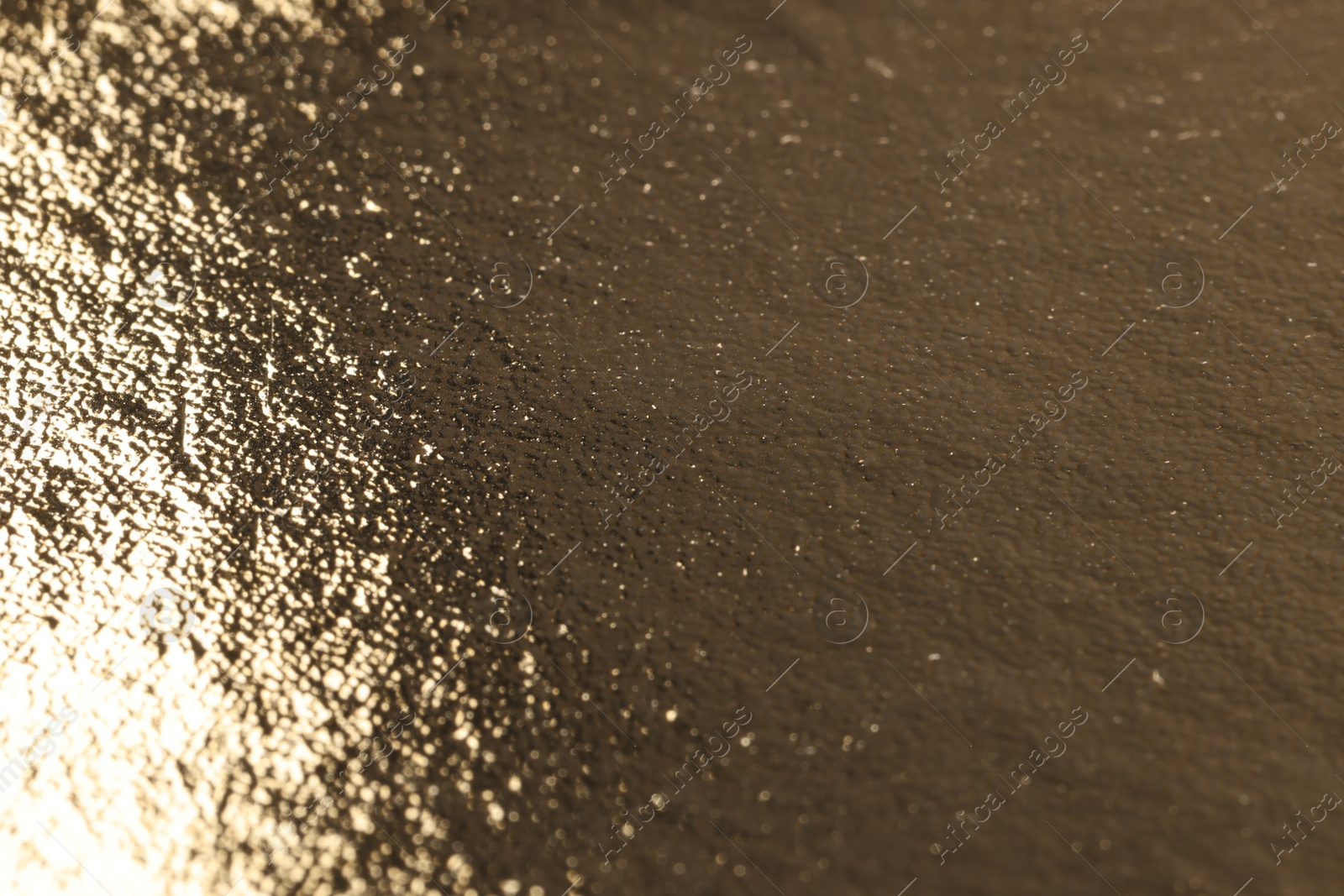 Photo of Edible gold leaf sheet as background, closeup