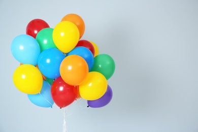 Photo of Bunch of bright balloons and space for text against white background