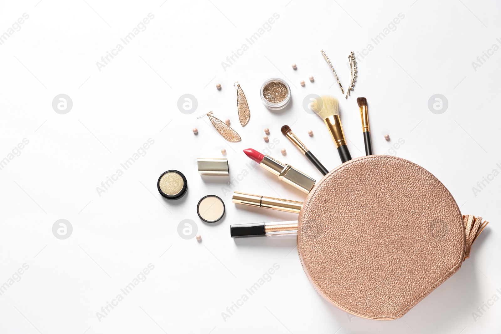 Photo of Cosmetic bag and different luxury makeup products on white background, top view