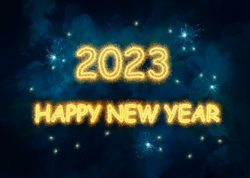 Image of 2023 Happy New Year made of sparkler on dark background. Greeting card design