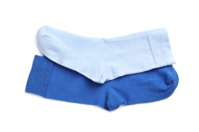 Photo of Different blue socks on white background, top view