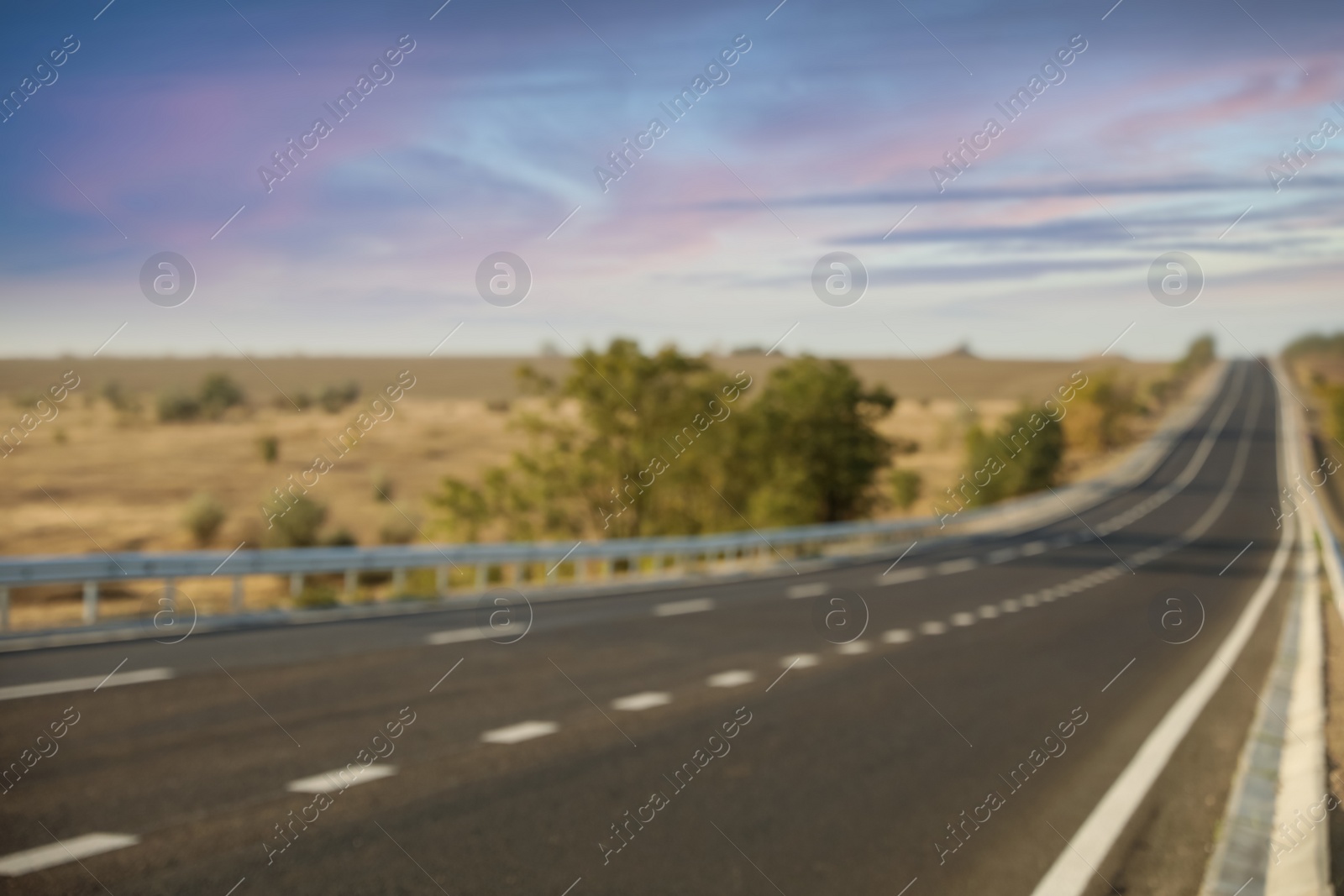 Photo of Blurred view of empty asphalt highway. Road trip