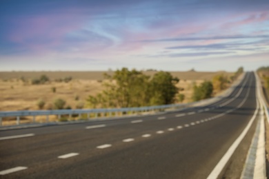 Photo of Blurred view of empty asphalt highway. Road trip