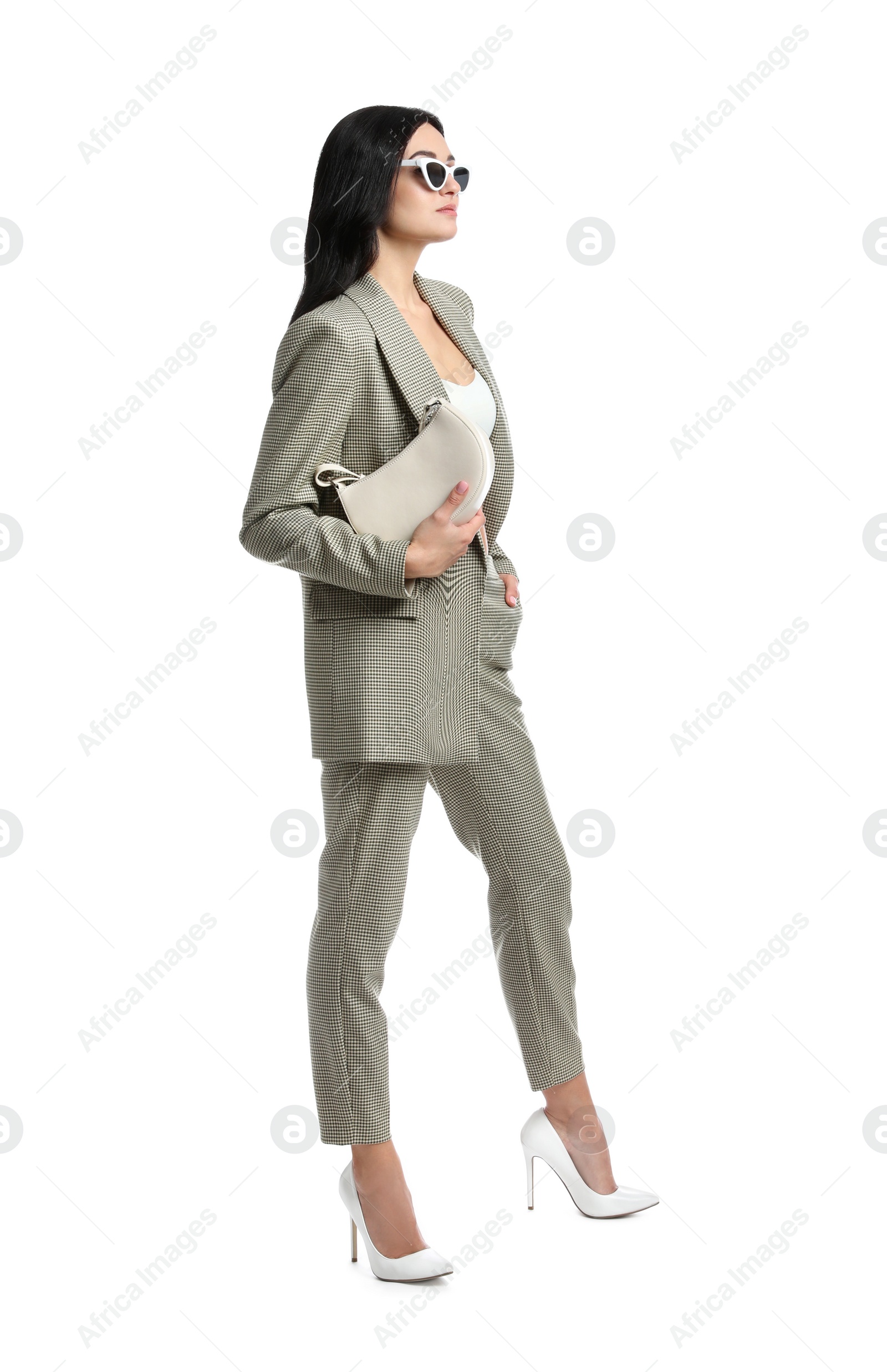 Photo of Full length portrait of beautiful woman with sunglasses and bag in formal suit on white background