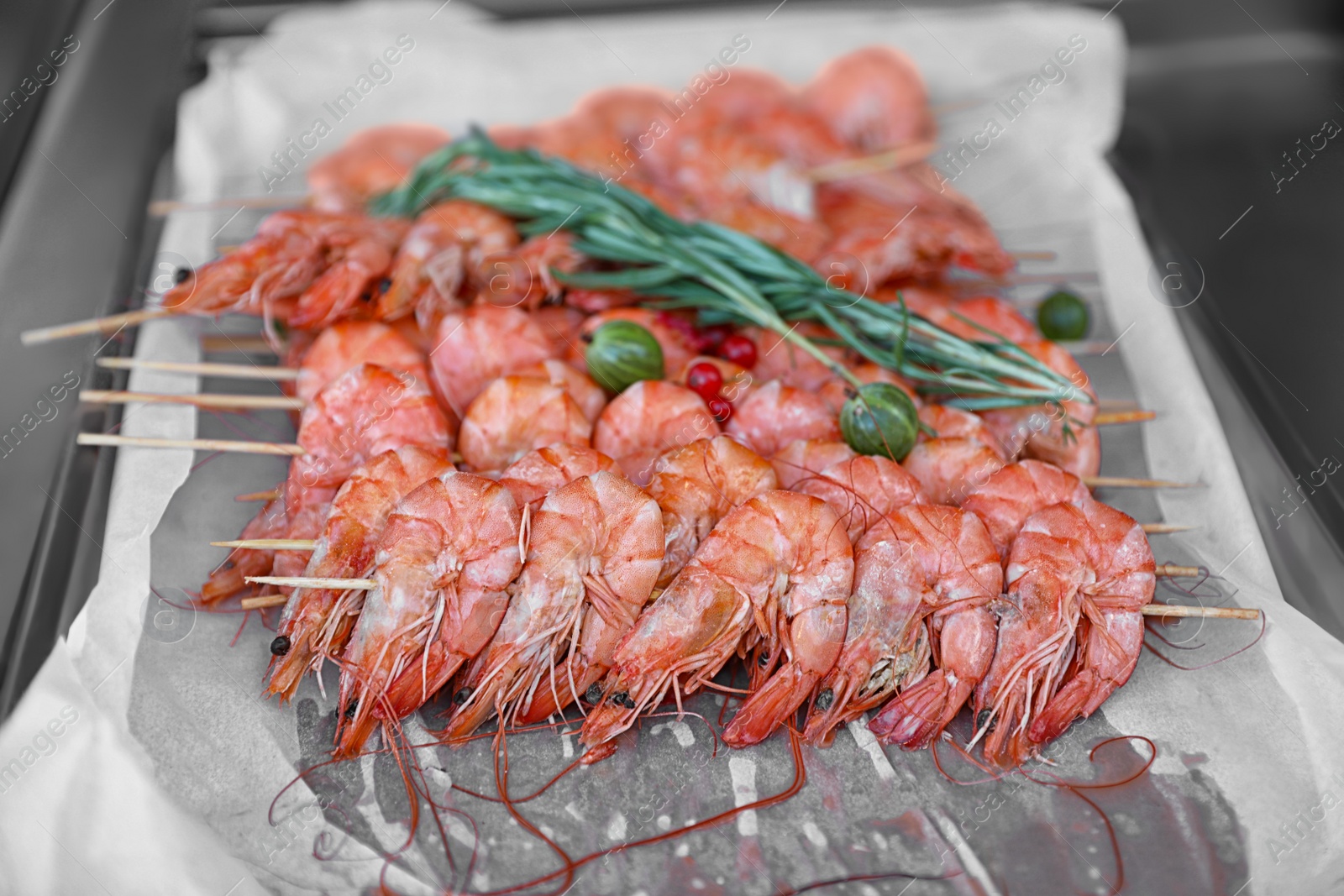 Photo of Delicious fresh shrimp skewers served on parchment