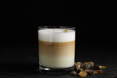 Photo of Delicious latte macchiato on table against black background