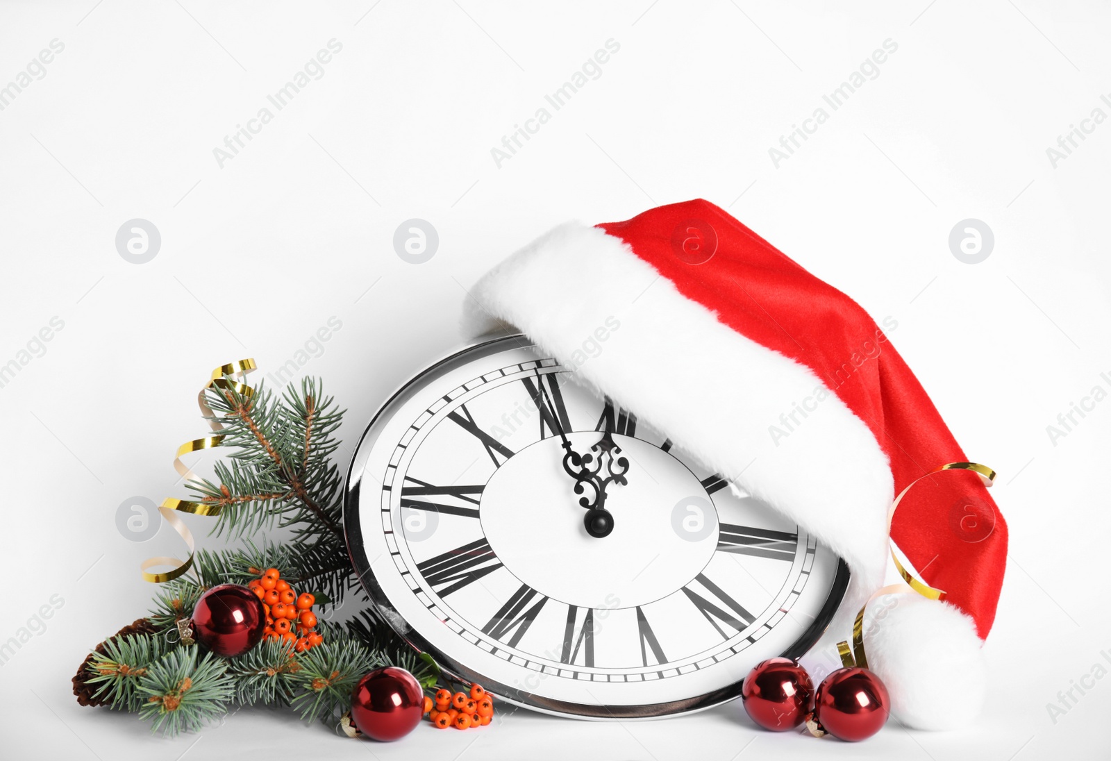 Photo of Clock and festive decor on white background. New Year countdown