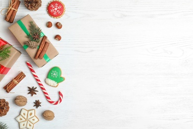 Photo of Flat lay composition with Christmas gift boxes on white wooden background. Space for text