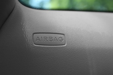 Safety airbag sign on door in car, closeup