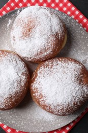 Photo of Delicious sweet buns with powdered sugar on table, top view