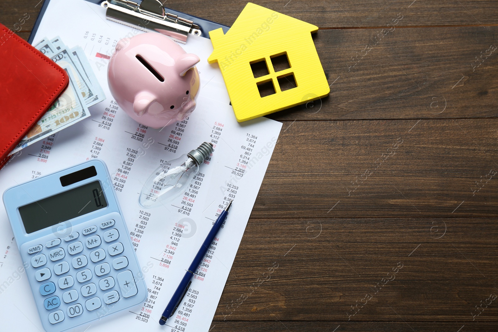 Photo of Flat lay composition with piggy bank and calculator on wooden table, space for text. Paying bills concept