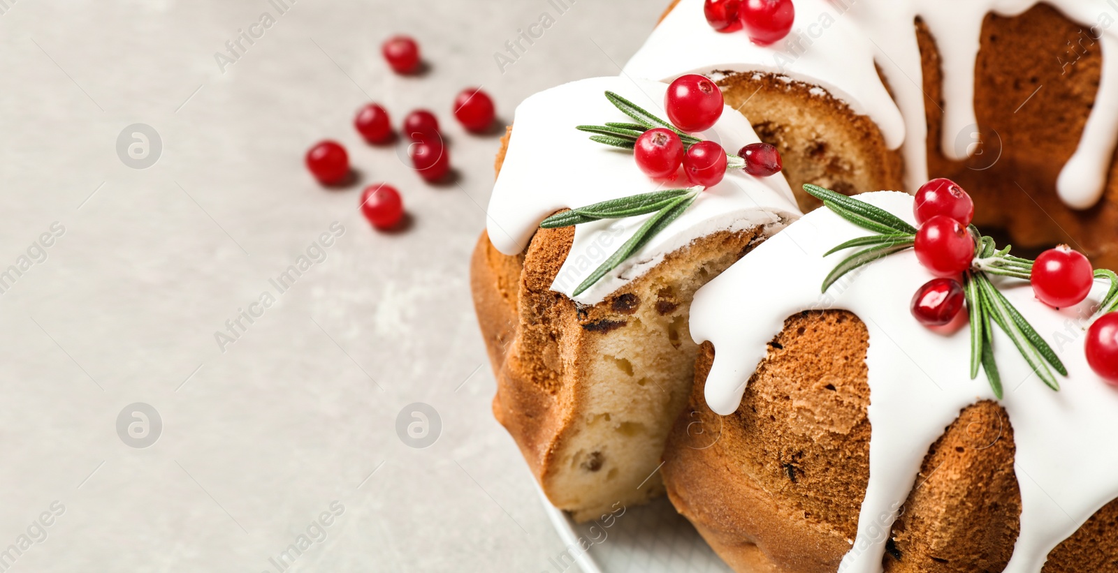 Image of Traditional homemade Christmas cake on light grey table, closeup view with space for text. Banner design 