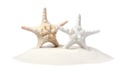 Photo of Beautiful sea stars in sand on white background