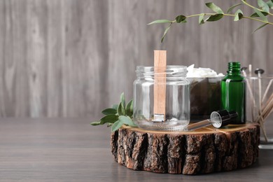 Composition with homemade candle ingredients on wooden table, space for text