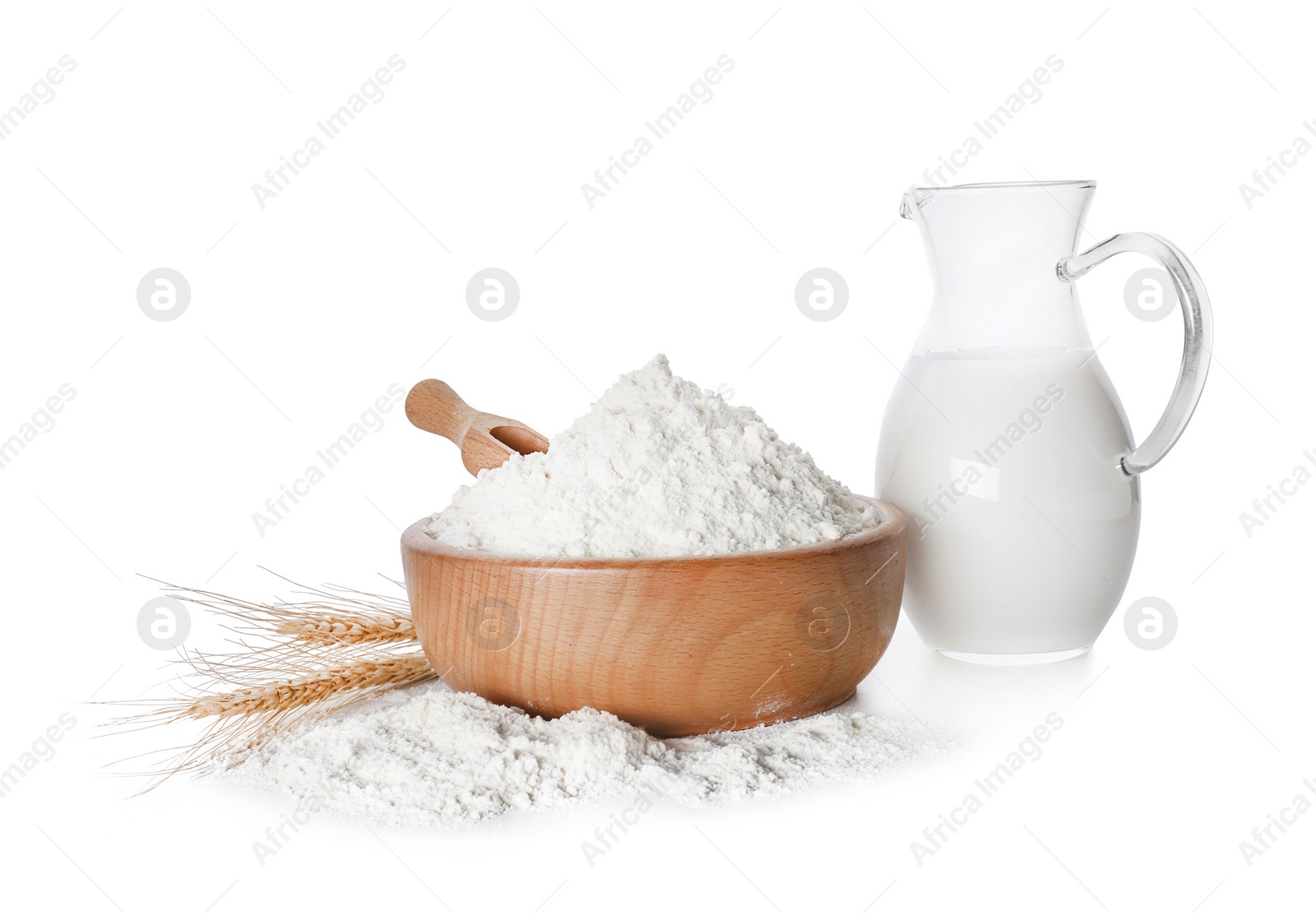 Photo of Wheat flour and jug of milk on white background