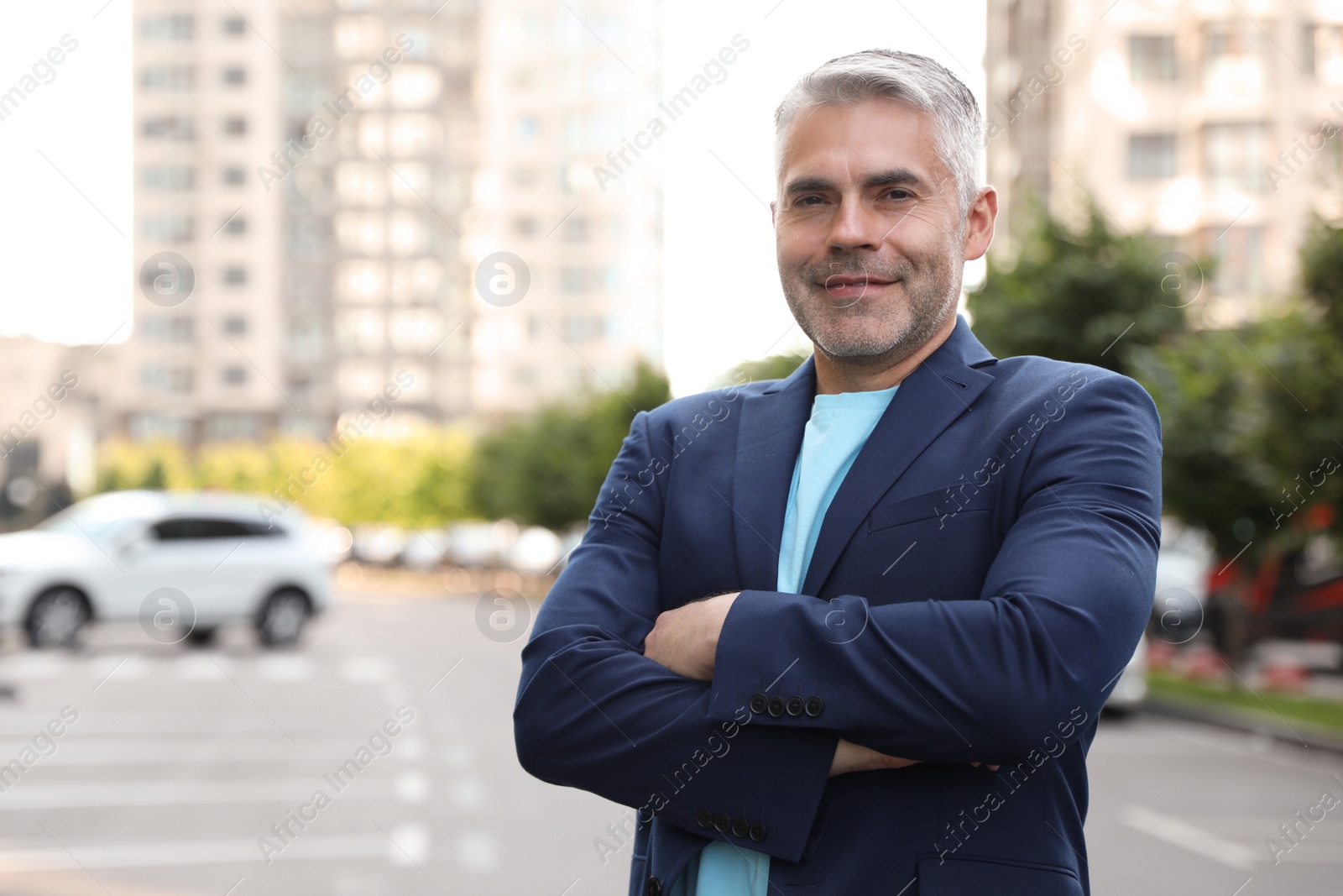 Photo of Portrait of handsome mature man in city center. Space for text