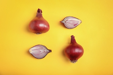 Photo of Beautiful composition with ripe red onions on color background