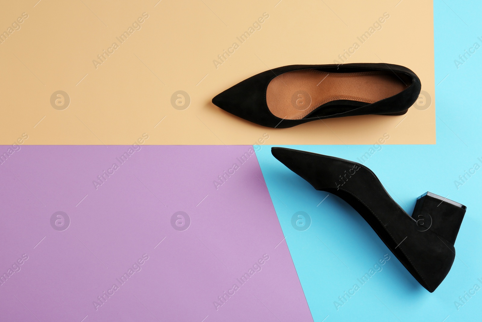 Photo of Pair of female shoes on color background, top view