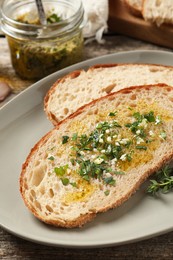 Photo of Tasty bruschettas with oil and garlic on table, closeup