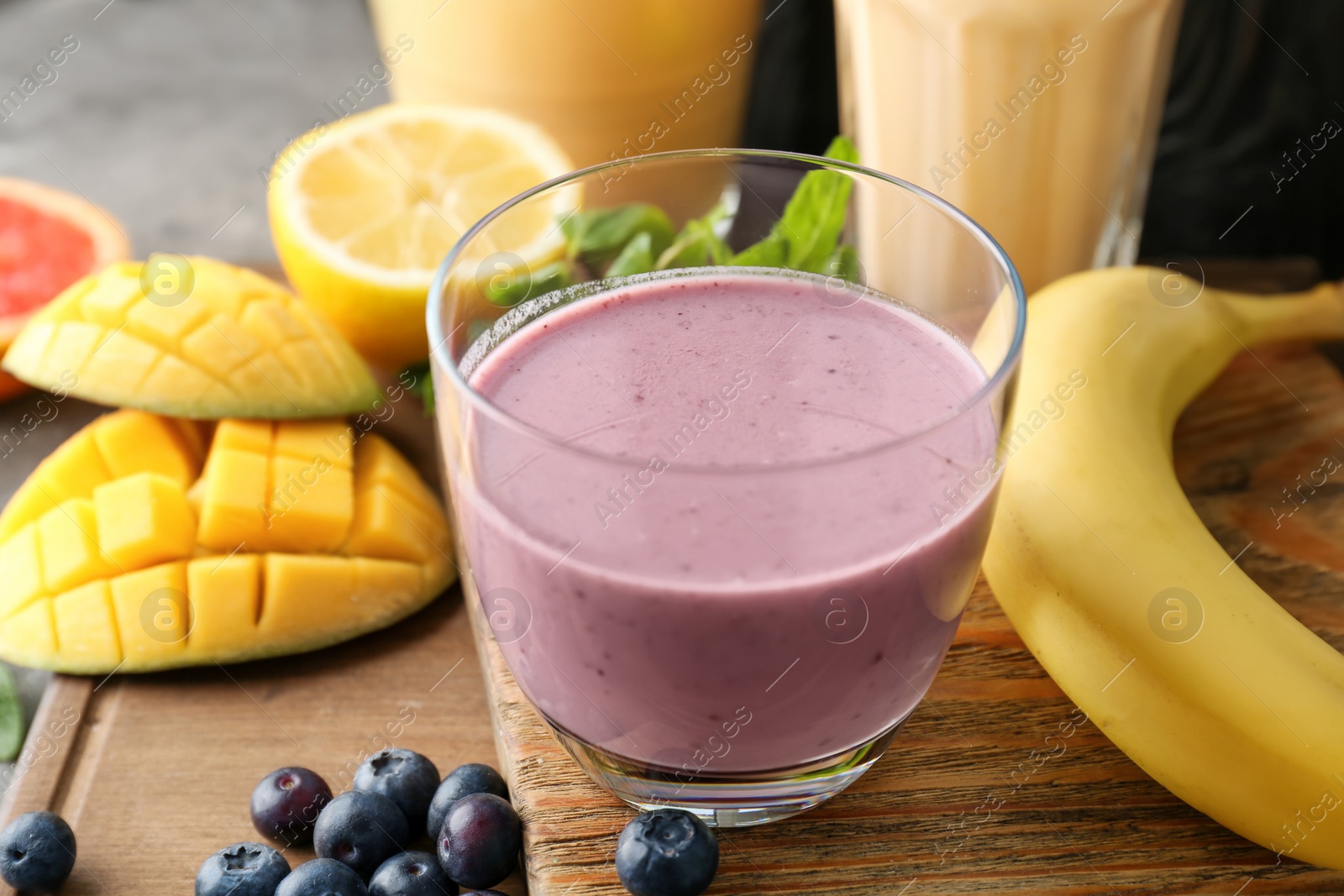 Photo of Glass with healthy detox smoothie and ingredients on table